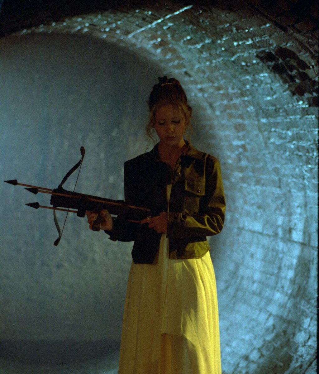 Sarah Michelle as Buffy The Vampire Slayer in a tunnel wearing a yellow dress and a leather jacket, ...