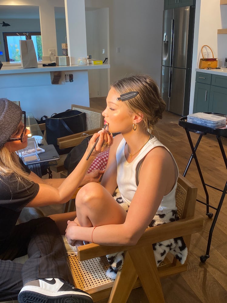 Olivia Holt Getting ready for dior party in hair and makeup chair