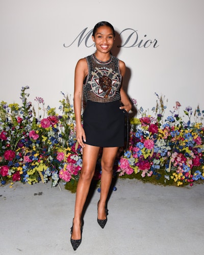 Yara Shahidi dressed in a transparent top with crystals and a lion print on it, and a black skirt wi...