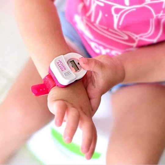Toddler wearing a potty training watch