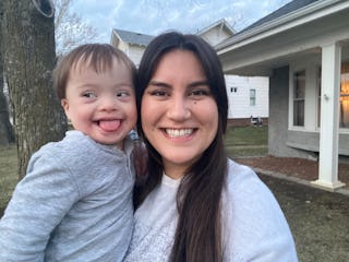 Mother carrying her child with Down Syndrome