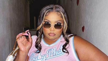 Lizzo with highlights, baby hairs, baby phat t-shirt