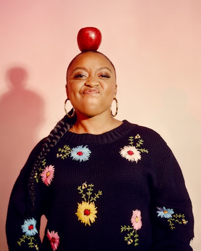 Brunson's confident smile with a red apple on her head
