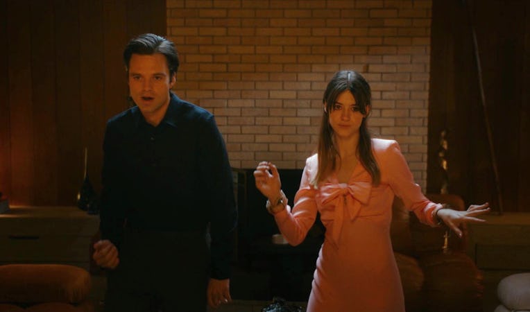A man and a woman dancing in a dark room.
