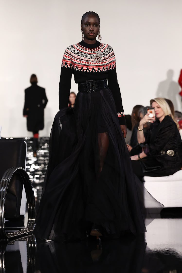 Model on the NY Fashion Week Fall 2022 runway in a Ralph Lauren knitted jumper, black belt, and a lo...