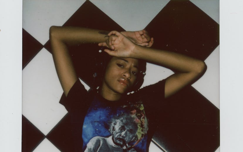 Kilo Kish lying on black and white tiles