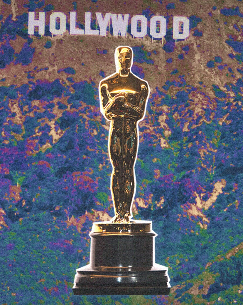 golden oscar statue in front of hollywood sign