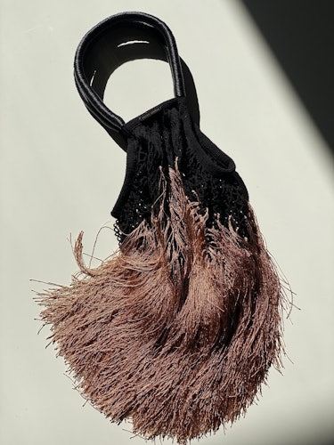 A fringe handbag by Petit Kouraj