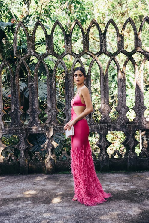 a hot pink gown with cutouts and feathers by Cult Gaia