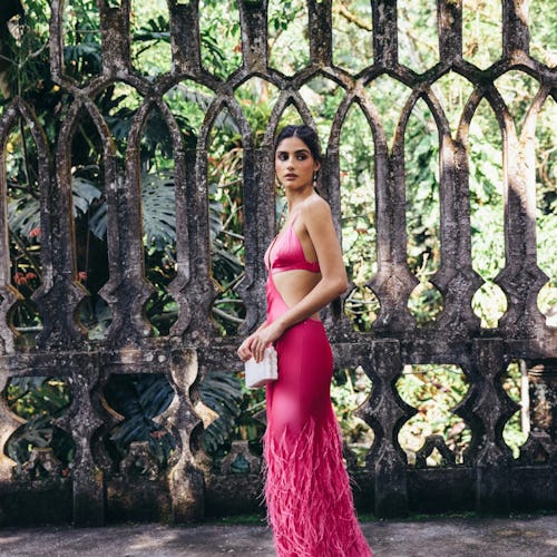 a hot pink gown with cutouts and feathers by Cult Gaia