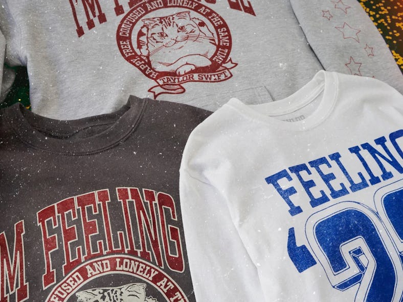 Taylor Swift's Feeling 2022 Graduation Collection includes sweatshirts, t-shirts, grad pins, and mor...