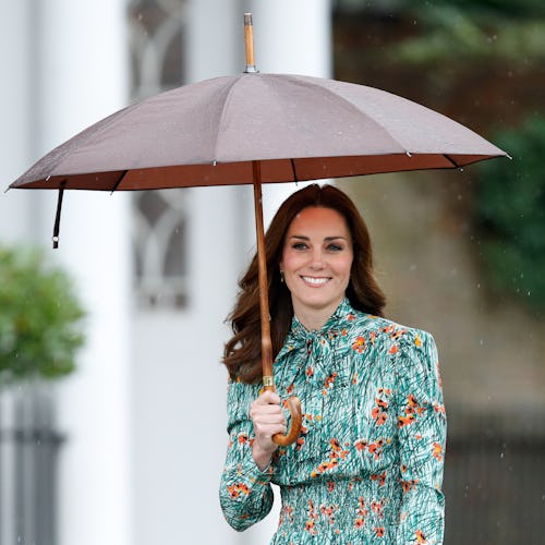 Kate Middleton wearing a floral dress in the rain