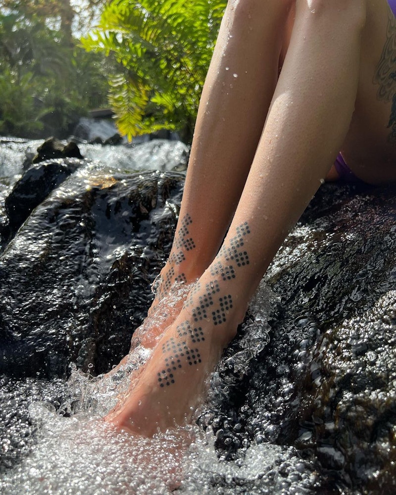 baby footprint tattoos on side