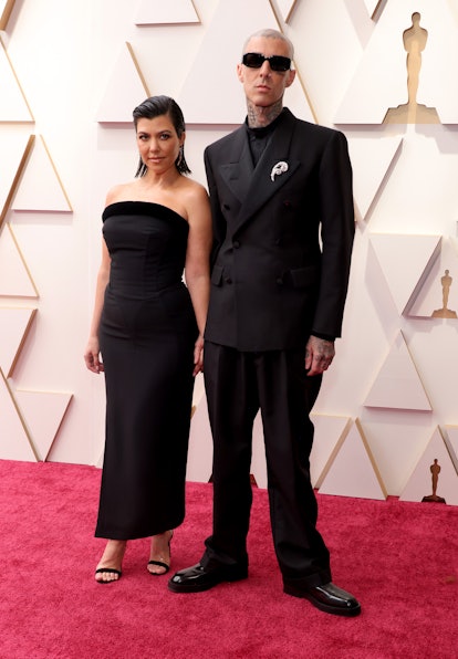 Kourtney Kardashian and Travis Barker attend the 94th Annual Academy Awards 