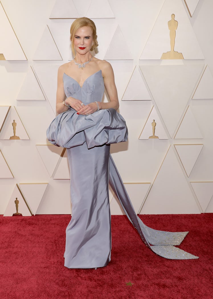 Nicole Kidman on the red carpet in a grey open-shoulder Armani Prive dress at the 2022 Oscars