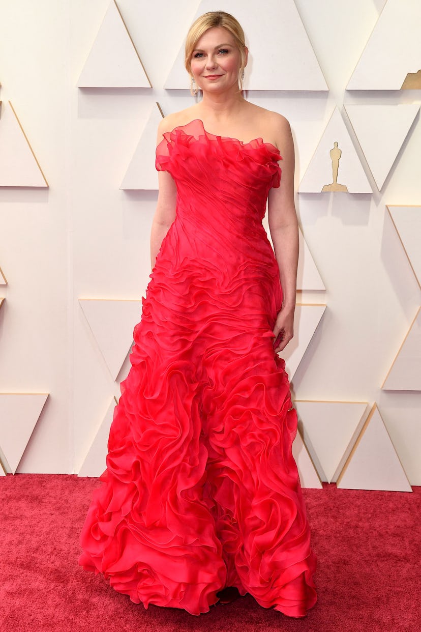 Kirsten Dunst wearing a red vintage Christian Lacroix gown to the 2022 Oscars