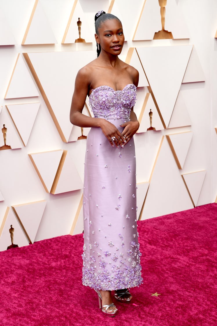 Demi Singleton on the red carpet wearing a violet Miu Miu dress with diamond details at the 2022 Osc...