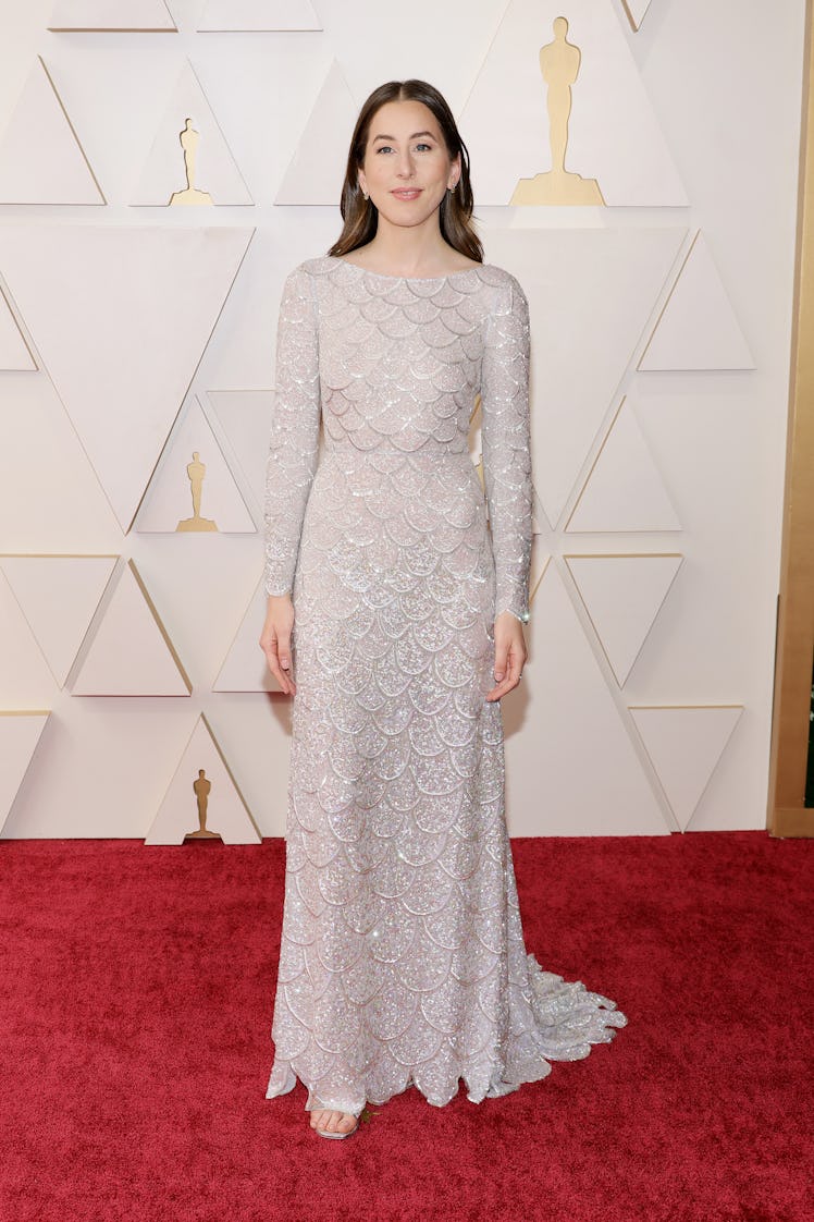 Alana Haim on the red carpet wearing a shiny silver Lous Vuitton dress at the 2022 Oscars