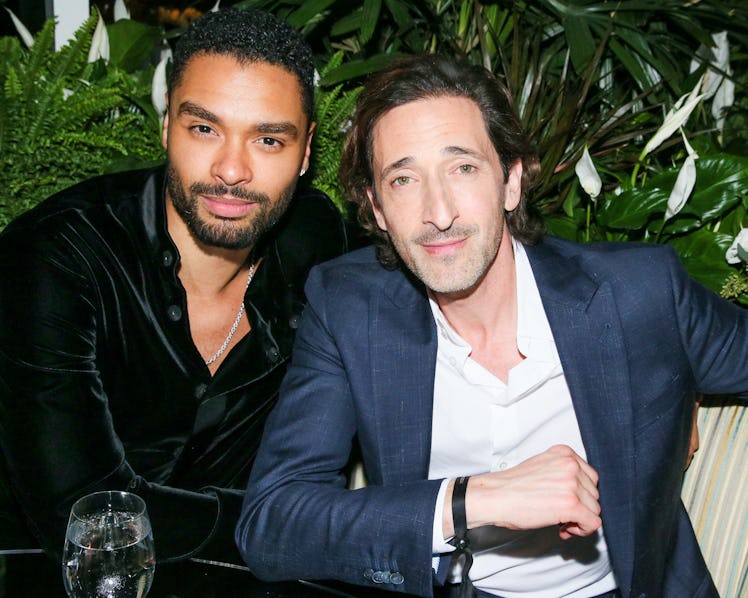 Regé-Jean Page in black velvet shirt and Adrien Brody in a blue suit