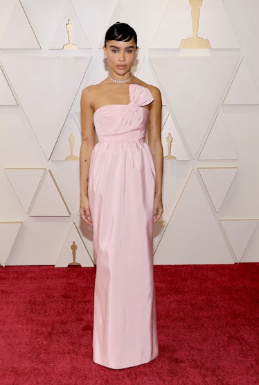 Zoë Kravitz on the red carpet in a pink open-shoulder Saint Laurent dress at the 2022 Oscars