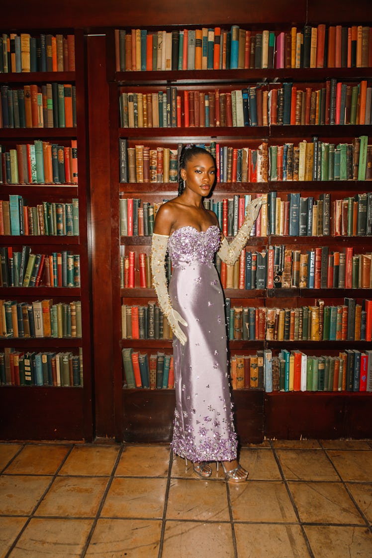 Demi Singleton in a lavender off-the-shoulder satin dress with crystal beads and white gloves in a l...