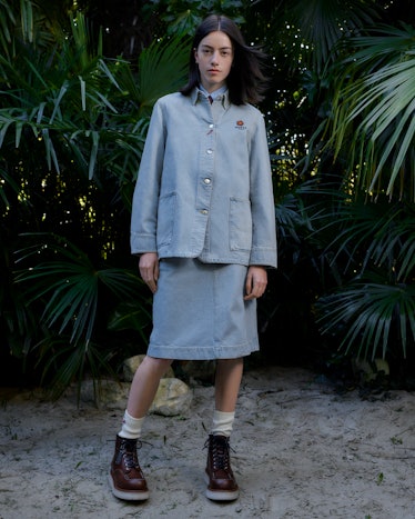 Model wearing a light denim jacket and skirt from Kenzo