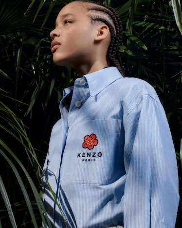 A detail shot of one of Kenzo's blue button-down shirts with embroidered flower detail