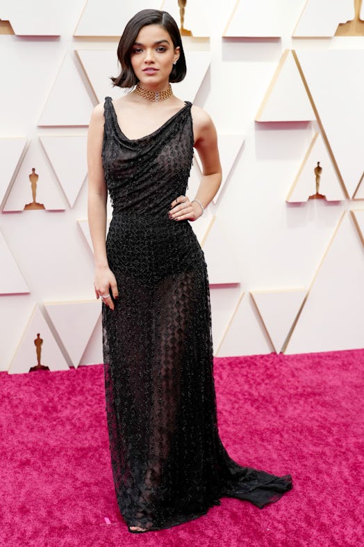 Rachel Zegler wears a sheer black dress on the 2022 Oscars red carpet.