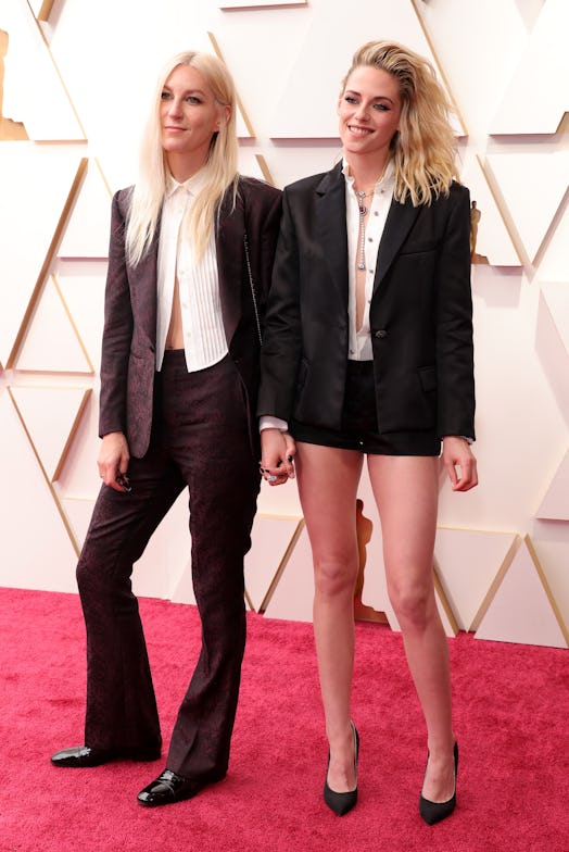 Dylan Meyer and Kristen Stewart holding hands at the 2022 Oscars