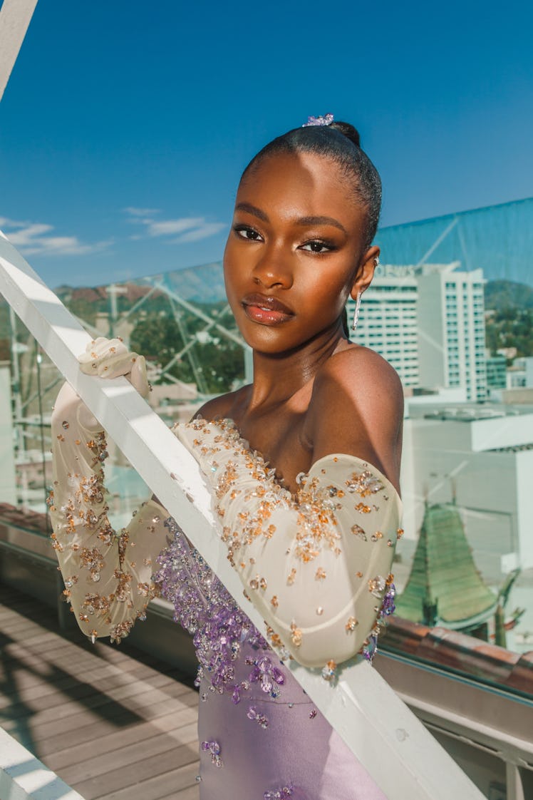 Demi Singleton in a lavender off-the-shoulder satin dress with crystal beads and white gloves at the...