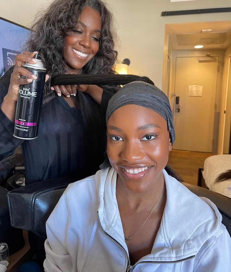 Demi Singleton in a selfie while getting her hair done by her hairstylist 