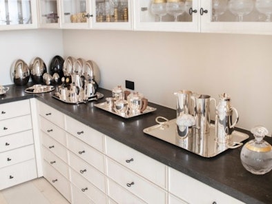 Kris Jenner's organization tips for her glassware and dishes include having her glasses on display. 
