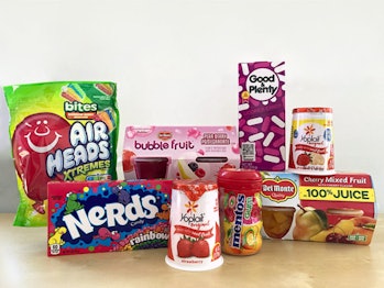 Photo of a display of packaged candy, yogurt and fruit, including AirHeads Xtremes Bites, rainbow Ne...