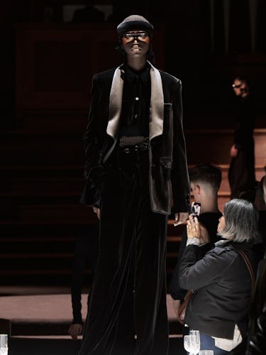 Model walking at Burberry show wearing all black tuxedo