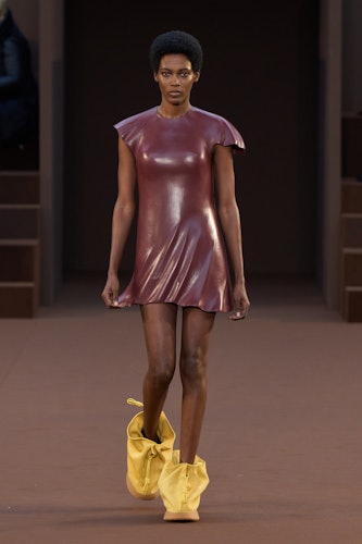 A model in a maroon dress and yellow boots by Loewe
