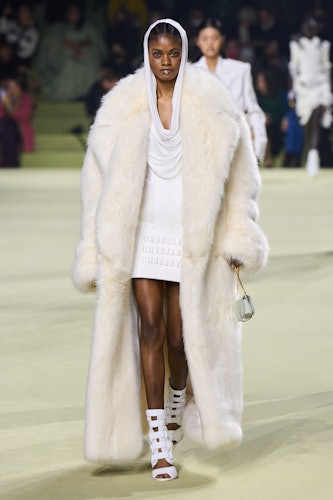 a model in white furs at the Balmain runway show