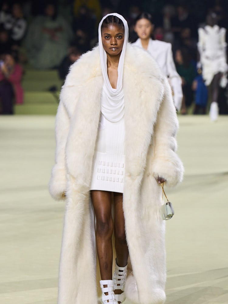 a model in white furs at the Balmain runway show