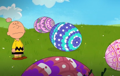 Charlie Brown winges in a field of colorful Easter eggs
