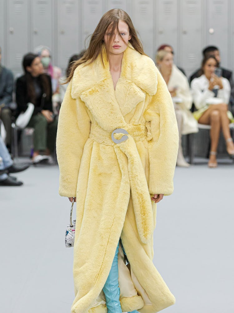 A model in a butter yellow Coperni coat