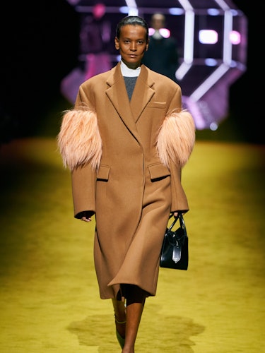 Liya Kebede in a Prada camel coat at the brand's runway show