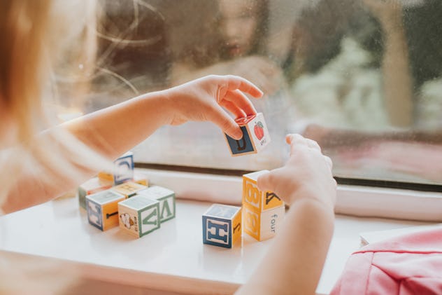 child playing with alphabet blocks