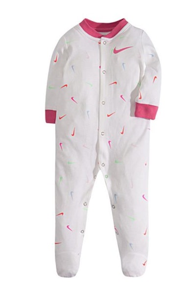 Flat lay of baby footie pjs with Nike symbol