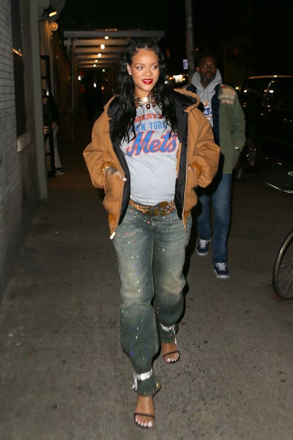 Pregnant Rihanna bares her baby bump as she returns to New York City with ASAP Rocky and her brother...