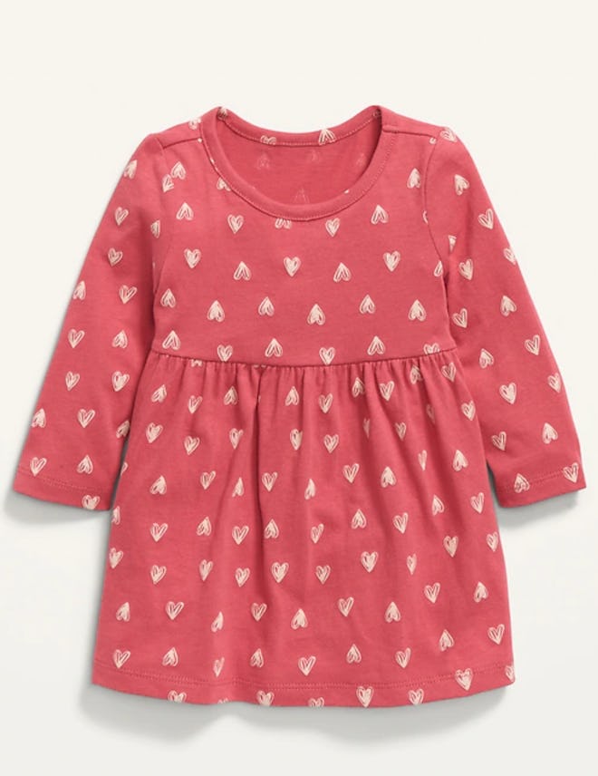Flat lay of baby dress with heart print