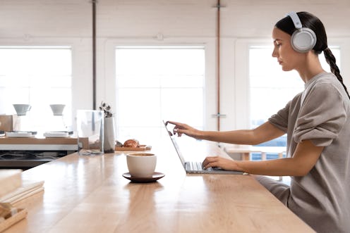 Woman working on slow computer. 