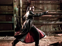 Wesley Snipes in Blade in a long leather jacket, pointing to the right