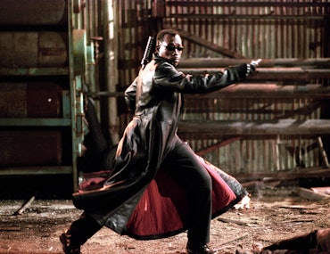 Wesley Snipes in Blade in a long leather jacket, pointing to the right