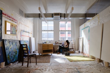 The artist Ana Benaroya sitting in her studio