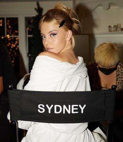 Sydney Sweeney looking ovr shoulder directors chair