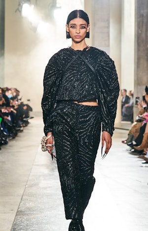 a model wearing an armor-inspire black top and pants on the Rochas runway